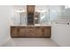 Bathroom with dual vanities, custom cabinets, framed mirrors, and a tile surround shower at 19566 Wood Farm Pl, Westfield, IN 46074
