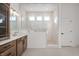 Bright bathroom with dual sink vanity, glass shower, tile surround, and modern fixtures at 19566 Wood Farm Pl, Westfield, IN 46074