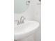 Bathroom featuring a pedestal sink with a round mirror, a towel holder, and an outlet at 19566 Wood Farm Pl, Westfield, IN 46074