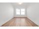 Bright and spacious bedroom with hardwood floors, white walls, and large windows at 19566 Wood Farm Pl, Westfield, IN 46074
