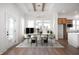 Elegant dining room with modern chandelier, hardwood floors, and lots of light at 19566 Wood Farm Pl, Westfield, IN 46074