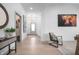 Bright and airy entryway with light hardwood floors and stylish decor at 19566 Wood Farm Pl, Westfield, IN 46074