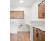 Laundry room featuring a desk, cabinets, laminate floors, and modern fixtures at 19566 Wood Farm Pl, Westfield, IN 46074