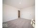 A carpeted bedroom is brightly lit with white walls and contains a closet and a doorway at 248 Highland Ave, Danville, IN 46122