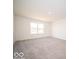 Bright bedroom with a large window providing ample natural light and plush carpeting at 248 Highland Ave, Danville, IN 46122