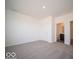 Spacious carpeted bedroom with a neutral color palette and a door to a bathroom at 248 Highland Ave, Danville, IN 46122