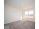 The carpeted bedroom is illuminated by natural light through a large window at 248 Highland Ave, Danville, IN 46122