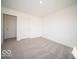 The bedroom features neutral carpet, and two doors, with crisp white walls at 248 Highland Ave, Danville, IN 46122