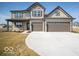 Charming two-story home featuring a neutral color scheme, two-car garage, and well-manicured lawn at 248 Highland Ave, Danville, IN 46122