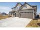 Charming two-story home featuring a neutral color scheme, two-car garage, and a large driveway at 248 Highland Ave, Danville, IN 46122