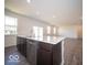 Stylish kitchen island with stainless steel appliances and grey wood floors at 248 Highland Ave, Danville, IN 46122
