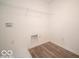 The laundry room is equipped with essential hookups and a practical wire shelf for storage at 248 Highland Ave, Danville, IN 46122