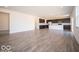 Open concept living room with grey wood floors flowing into the modern kitchen at 248 Highland Ave, Danville, IN 46122