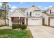 Two-story beige house with brick accents, a two-car garage, and landscaping at 2746 Cadogan Dr, Greenwood, IN 46143