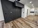 Modern living room with geometric dark accent wall and light wood floors at 3271 Winthrop Ave, Indianapolis, IN 46205