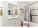 Well-lit bathroom featuring a single sink vanity and tiled shower/tub with stylish shower curtain at 359 Terrace Ave, Indianapolis, IN 46225