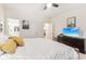 Bright bedroom featuring white walls, ceiling fan and TV with en-suite bathroom and plenty of natural light at 359 Terrace Ave, Indianapolis, IN 46225