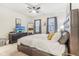 This bedroom features a TV, ceiling fan, a tufted headboard, and comfortable bedding, creating a relaxing atmosphere at 359 Terrace Ave, Indianapolis, IN 46225
