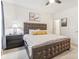 Inviting bedroom featuring a tufted headboard, soft carpet, and natural light with decorative lighting at 359 Terrace Ave, Indianapolis, IN 46225
