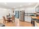 Open floor plan of a cozy kitchen and dining area with white cabinets, stainless steel appliances and outdoor access at 359 Terrace Ave, Indianapolis, IN 46225
