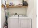 Laundry room featuring a Whirlpool washer and dryer with overhead shelving at 359 Terrace Ave, Indianapolis, IN 46225