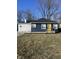 Charming ranch home with a blue exterior, white stone accents, and a yellow front door at 3712 N Bancroft St, Indianapolis, IN 46218