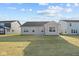 Beige house exterior with a backyard and neighboring houses visible at 3950 Bozeman Way, Bargersville, IN 46106