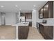Open kitchen with island, dark cabinetry, and stainless steel appliances at 3950 Bozeman Way, Bargersville, IN 46106