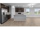 Modern kitchen with island, stainless steel appliances, and hardwood floors at 3950 Bozeman Way, Bargersville, IN 46106