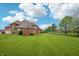 Expansive backyard featuring lush green grass and mature trees, perfect for outdoor activities at 1038 White Oak Dr, Plainfield, IN 46168