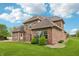 Brick home surrounded by well-maintained green lawn and landscaped shrubbery at 1038 White Oak Dr, Plainfield, IN 46168