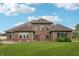 Brick home with a manicured lawn, mature landscaping, and architectural details at 1038 White Oak Dr, Plainfield, IN 46168