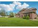 Brick home on a lush lawn with mature trees and architectural details at 1038 White Oak Dr, Plainfield, IN 46168