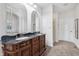 Elegant bathroom featuring a large double vanity with decorative cabinetry and ornate arched mirrors at 1038 White Oak Dr, Plainfield, IN 46168
