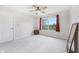 Cozy bedroom featuring a ceiling fan, plush carpet, and large window at 1038 White Oak Dr, Plainfield, IN 46168