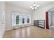 Bright dining area with laminate flooring, ample natural light, and elegant chandelier at 1038 White Oak Dr, Plainfield, IN 46168