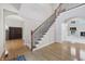 Elegant foyer featuring hardwood floors, staircase with iron balusters, and an open layout at 1038 White Oak Dr, Plainfield, IN 46168