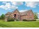 Stately brick home featuring a lush lawn and mature landscaping, creating an inviting exterior at 1038 White Oak Dr, Plainfield, IN 46168