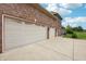 Attached three-car garage with concrete driveway providing ample parking space at 1038 White Oak Dr, Plainfield, IN 46168