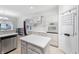 Well-lit kitchen with stainless steel appliances, granite countertops, a kitchen island, and wood flooring at 1038 White Oak Dr, Plainfield, IN 46168