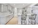 Well-lit kitchen with modern cabinetry, stainless steel appliances, breakfast bar, and wood flooring at 1038 White Oak Dr, Plainfield, IN 46168
