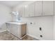 Spacious laundry room featuring ample counter space and storage cabinets at 1038 White Oak Dr, Plainfield, IN 46168