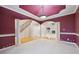Spacious living room with decorative pillars leading to an open staircase and a view of the fireplace at 1038 White Oak Dr, Plainfield, IN 46168