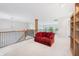 Bright upper level featuring a cozy sofa, railing, and built in bookshelves at 1038 White Oak Dr, Plainfield, IN 46168