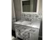Bathroom featuring a modern vanity with marble countertop, tiled backsplash, and updated fixtures at 2104 N Ball Ave, Muncie, IN 47304