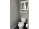 Bathroom featuring toilet and storage with white cabinets, drawers, and a clean design at 2104 N Ball Ave, Muncie, IN 47304