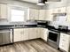 Well-equipped kitchen featuring stainless steel appliances and white cabinetry for a modern, clean aesthetic at 2104 N Ball Ave, Muncie, IN 47304