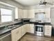 Bright kitchen featuring modern appliances, white cabinetry, and tile backsplash at 2104 N Ball Ave, Muncie, IN 47304