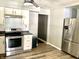 Well-lit kitchen boasts stainless steel appliances, white cabinets, and modern fixtures at 2104 N Ball Ave, Muncie, IN 47304