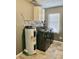 Functional laundry room with modern washer/dryer, water heater, and storage cabinets at 2104 N Ball Ave, Muncie, IN 47304